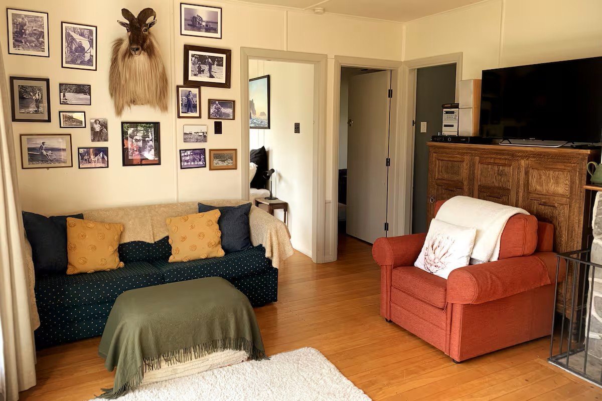 Living room with lake view through window, The Black Shack