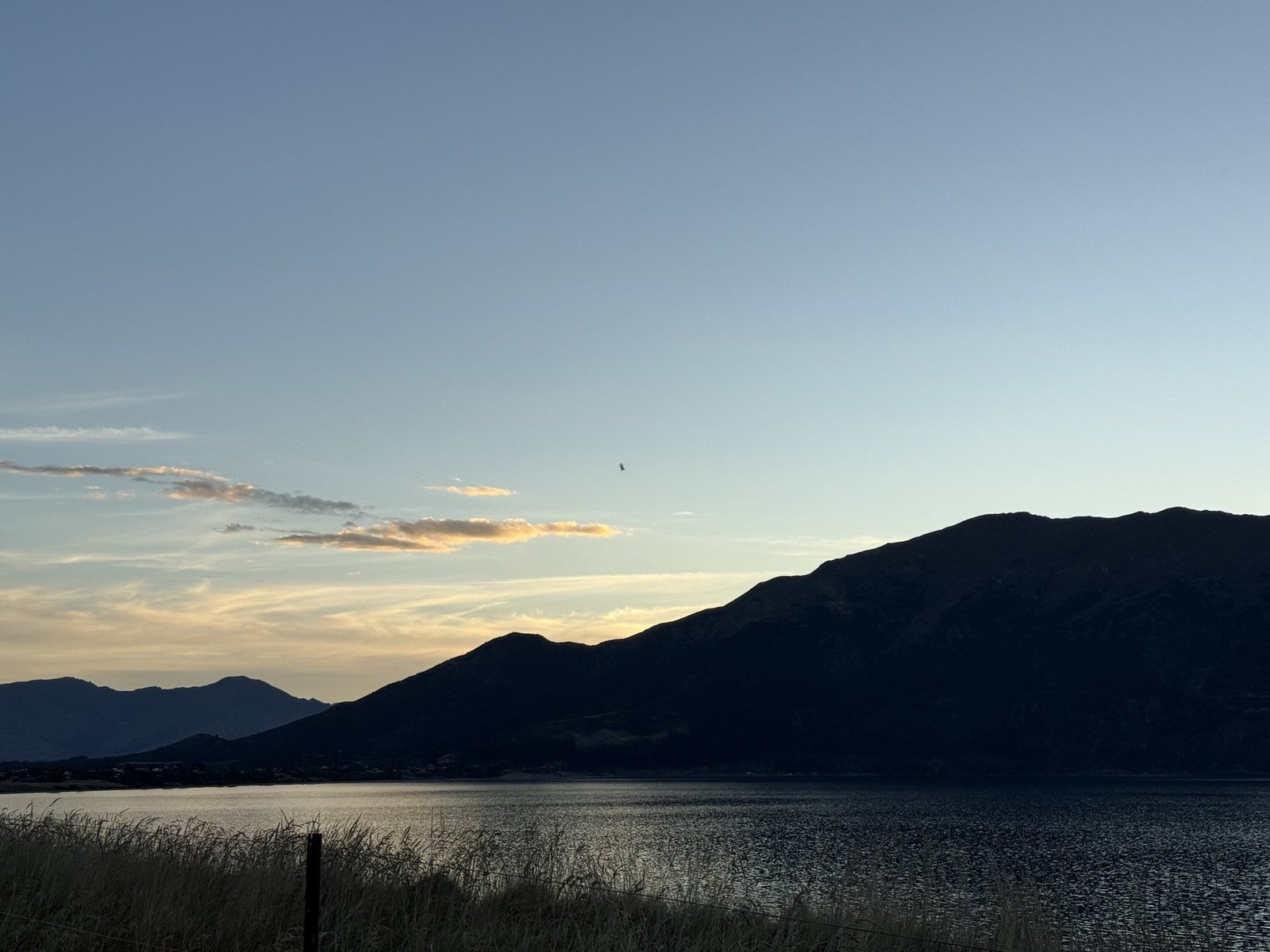 Lake Hawea at sunset, silhouetted mountains