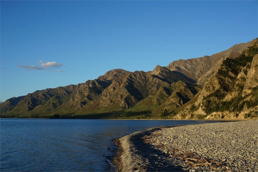 Lake Hawea shoreline with mountains